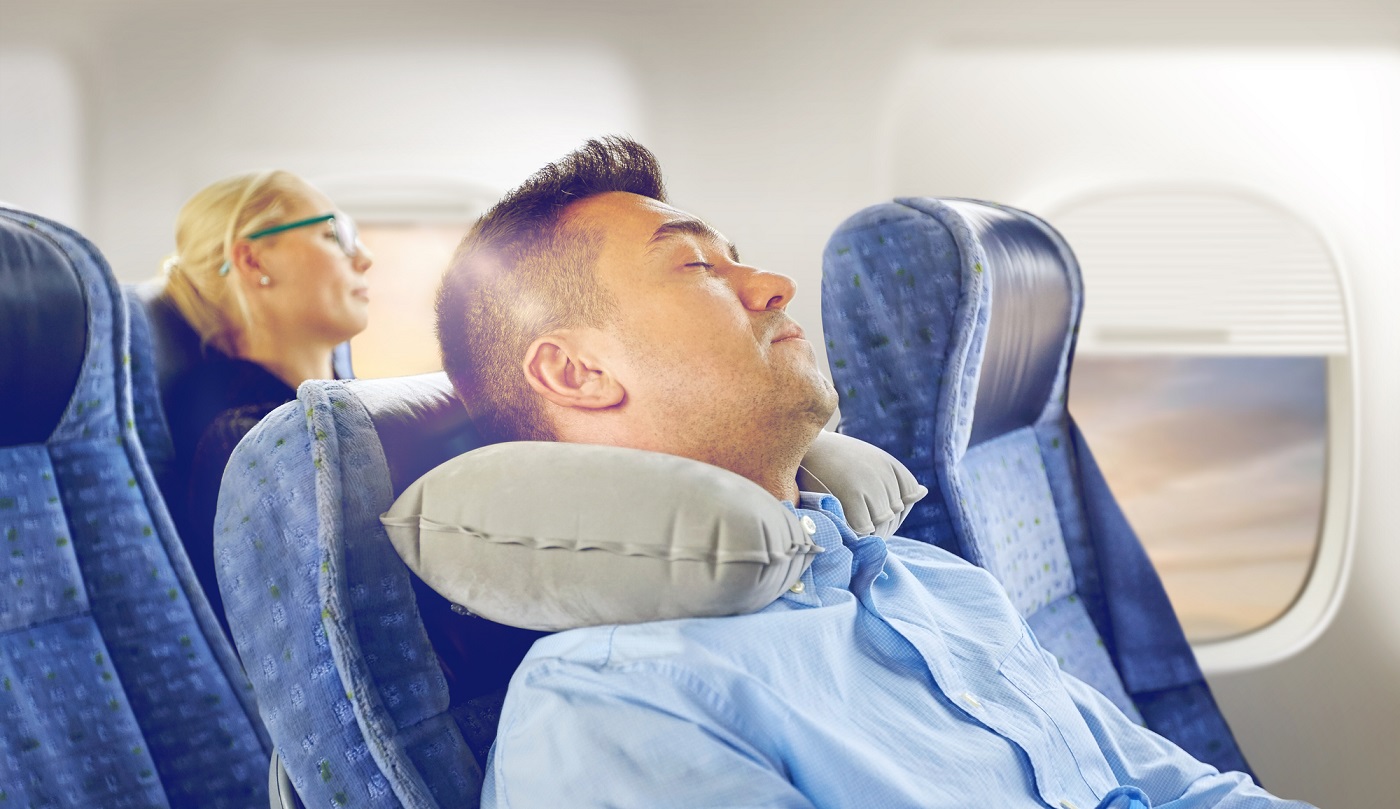 Man sleeping on airplane seat